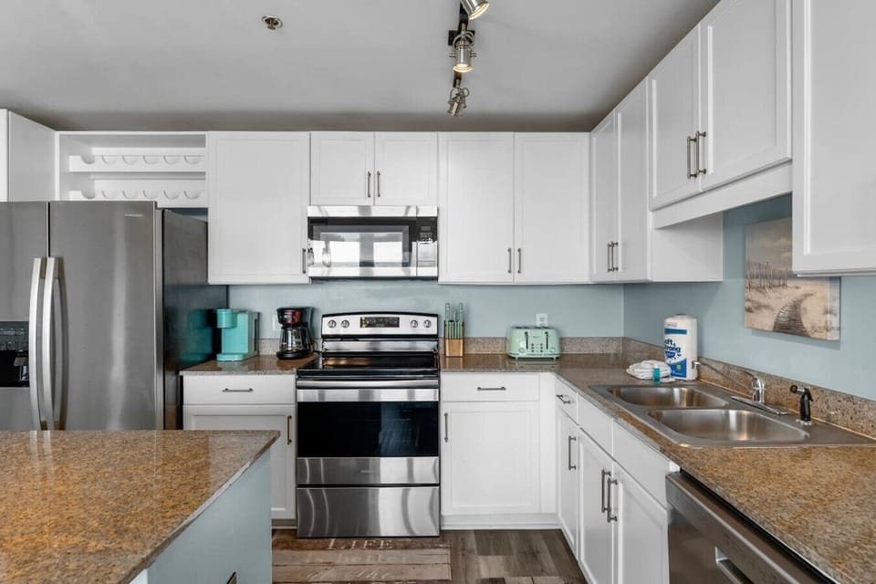 Fully equipped kitchen with granite counters and stainless appliances.
