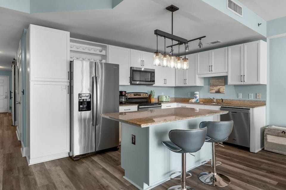 Fully equipped kitchen with granite counters and stainless appliances.