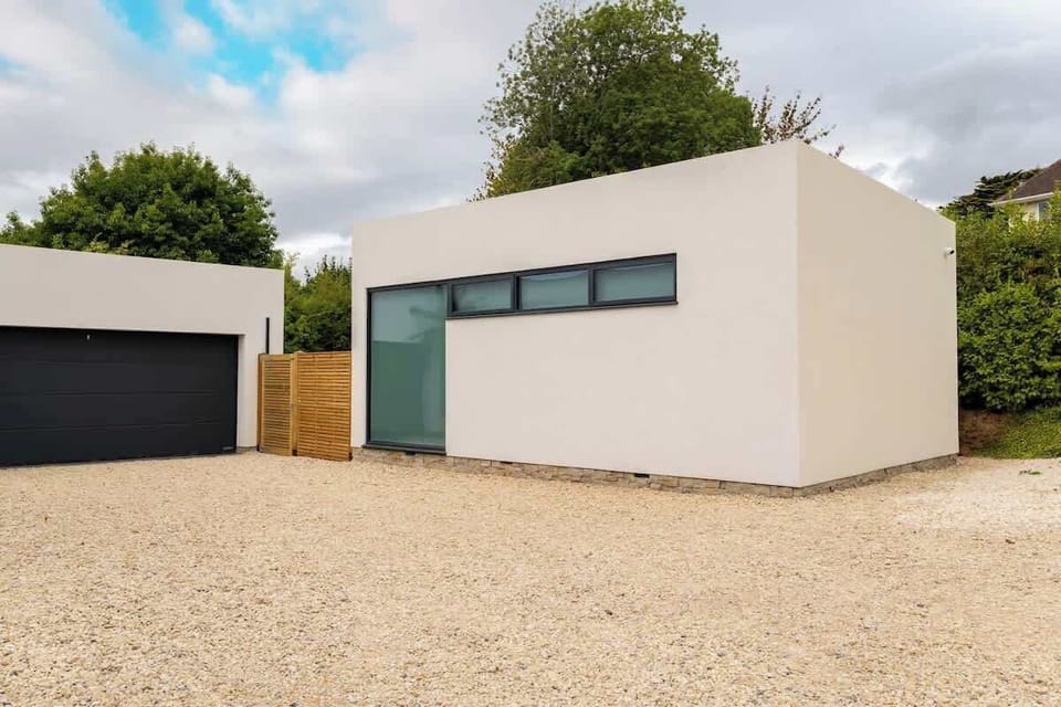 A minimalist exterior gives way to a cosy retreat, perfect for starlit evenings in the hot tub and slow mornings together.