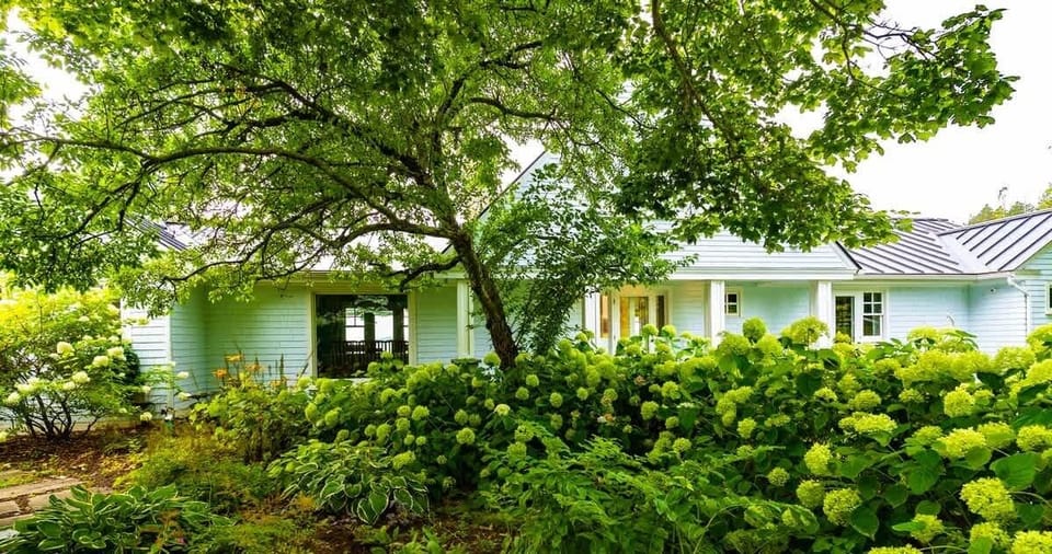 The house is surrounded by lush gardens and granite patios!