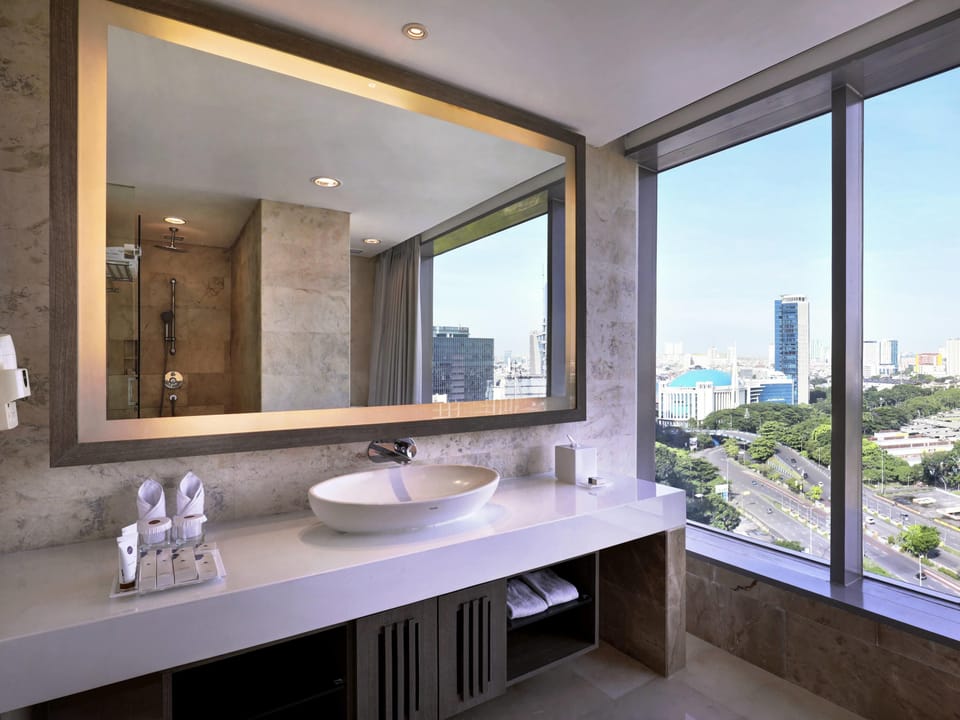 Eco-friendly toiletries, hair dryer, slippers, towels