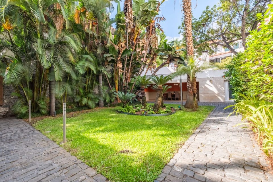 Relax in a tranquil, private garden surrounded by tropical vegetation and timeless stone paths.