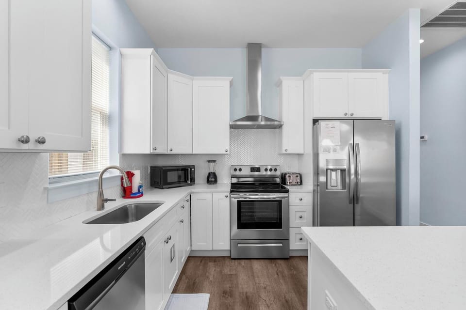 Modern kitchen with stainless steel appliances and ample counter space.