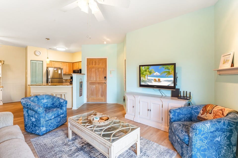 Main Living Area: Open-concept living with 9' ceilings, comfy seating, and a flat-screen TV—perfect for family movie nights.