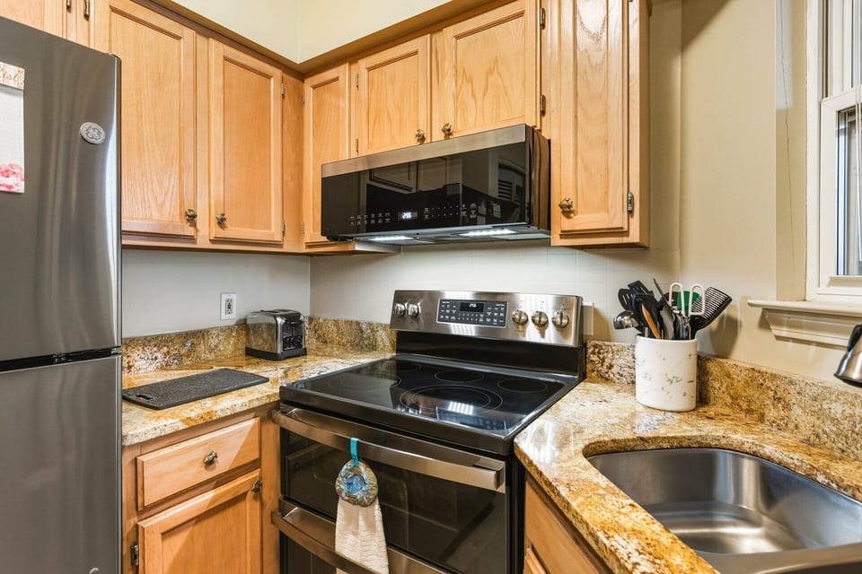 Dining Area & Kitchen: Fully equipped kitchen with breakfast bar and dining space for four, ideal for casual meals as a family.