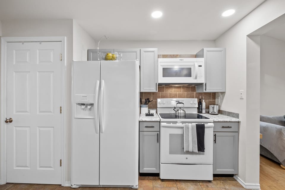 Kitchen: Cook up a feast in this stylish space with modern appliances and bright lighting!