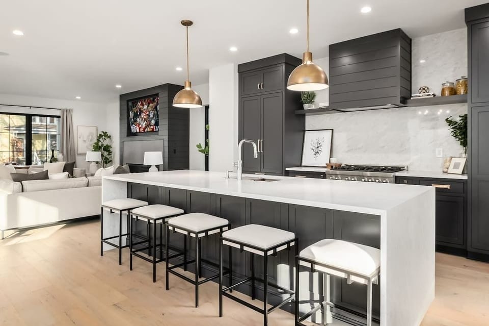 Custom Kitchen with waterfall countertops and barstool seating