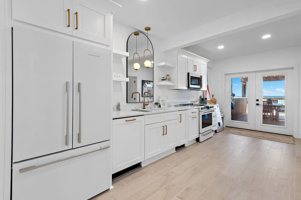 First Floor Kitchen also allows for Gulf view food prep! Plus, there's a convenient cabinet ice maker! 