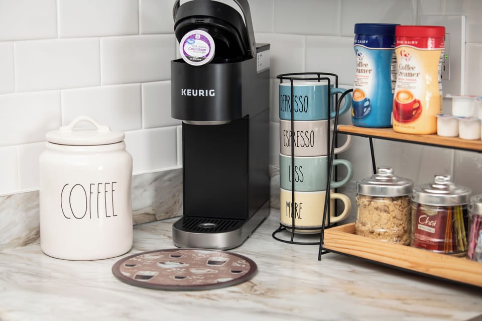 Coffee corner stocked with essentials—start your day right with a fresh brew at your convenience.