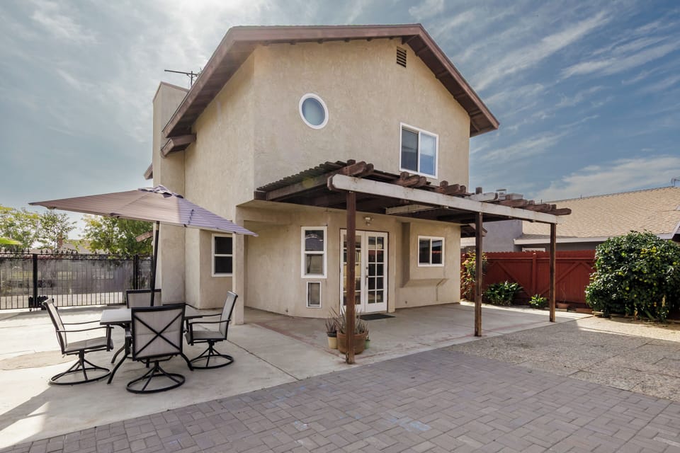 Private backyard patio with shade umbrella and seating