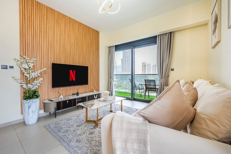 A stylish lounge with elegant decor and a Smart TV with Burj view.