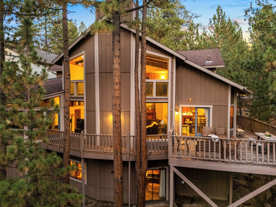 Tucked away in the pines, this cabin's warm glow and inviting decks are the perfect welcome to your getaway.