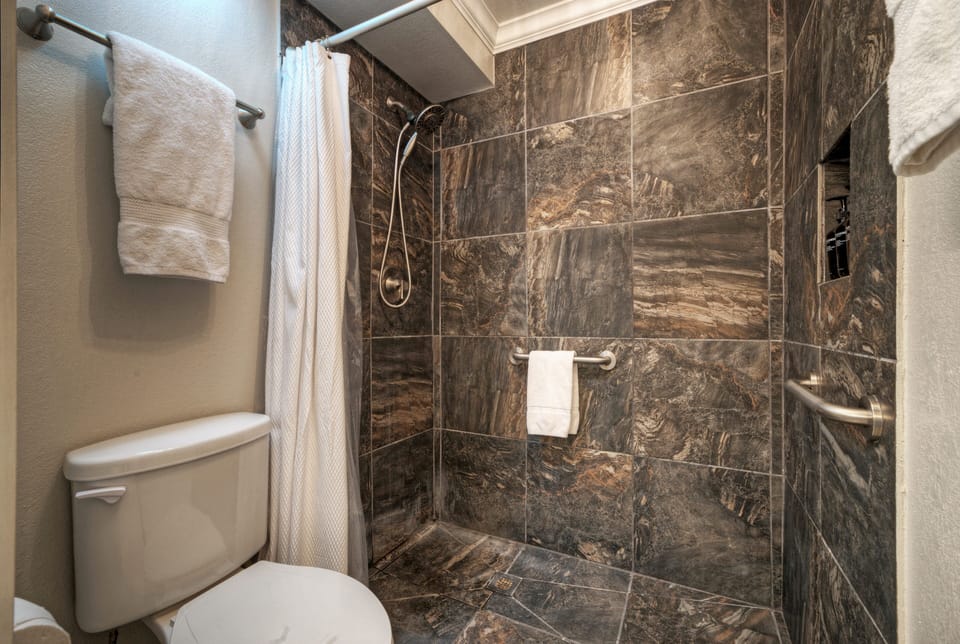 Ensuite bathroom 1 features a dual vanity and a walk-in shower.