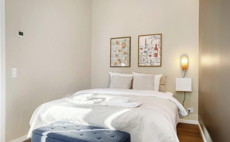 Double bedroom with blackout curtains, built-in closets and a comfortable queen bed