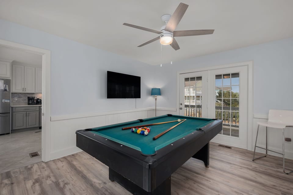Mid Level: Pool Table Lounge with a wall-mounted chess board and access to the front deck with seating