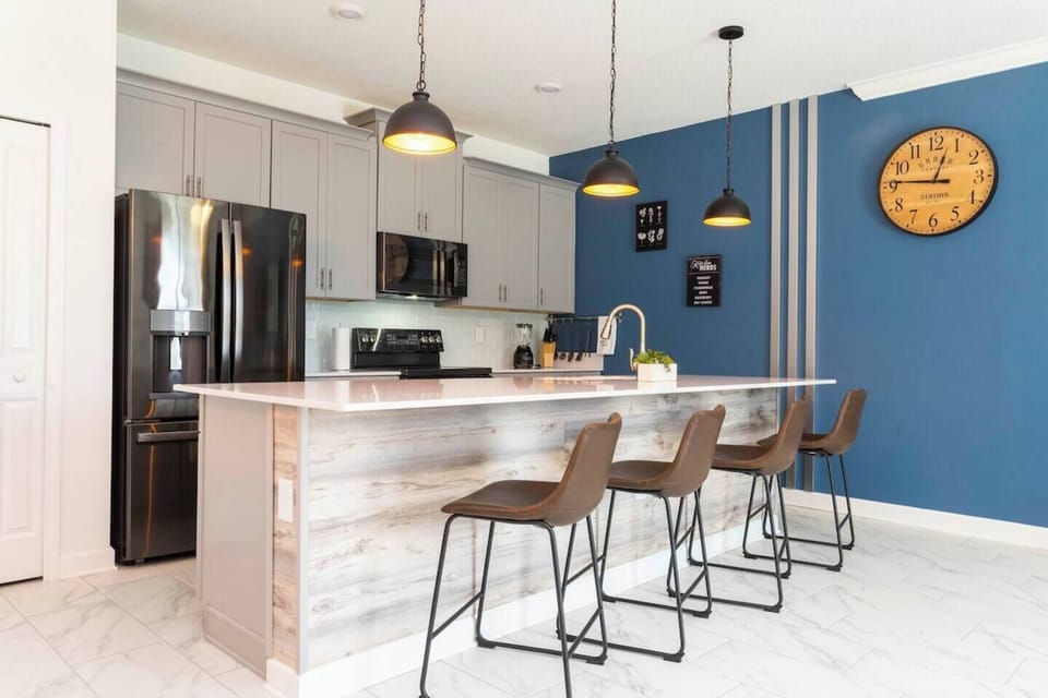The fully equipped kitchen features modern appliances, sleek cabinetry, and all essential cookware and utensils, making it perfect for preparing meals with ease.
