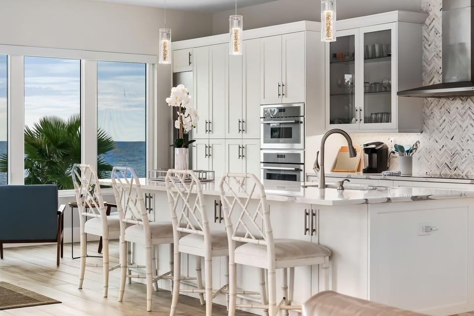 Cook and connect in a chef’s kitchen designed for gathering. With high-end appliances, an island breakfast bar, and ocean views, even meal prep feels like a vacation.