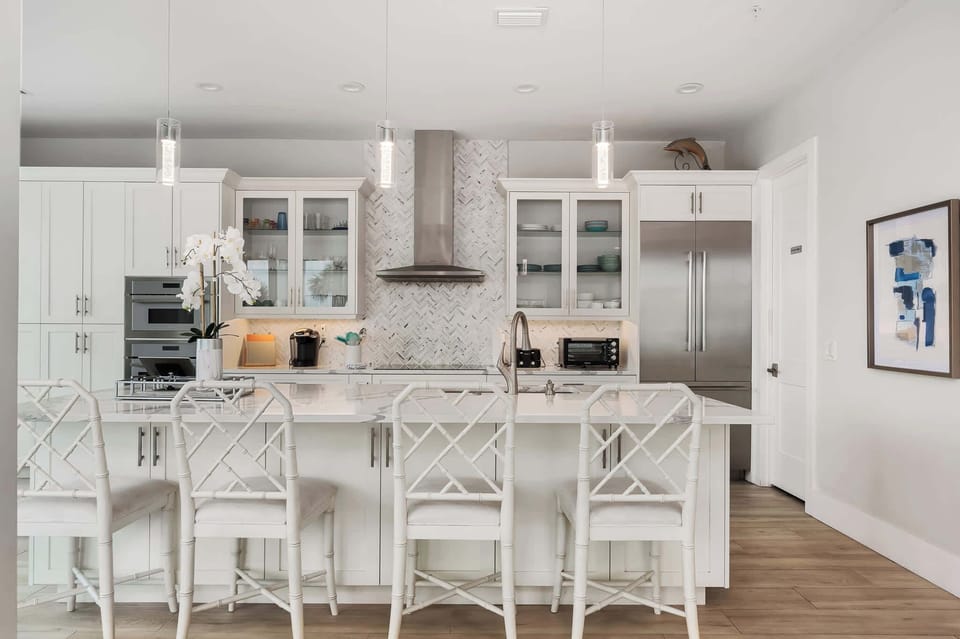 The open-concept kitchen connects seamlessly to the dining and living spaces, ensuring everyone stays connected while meals are prepared.