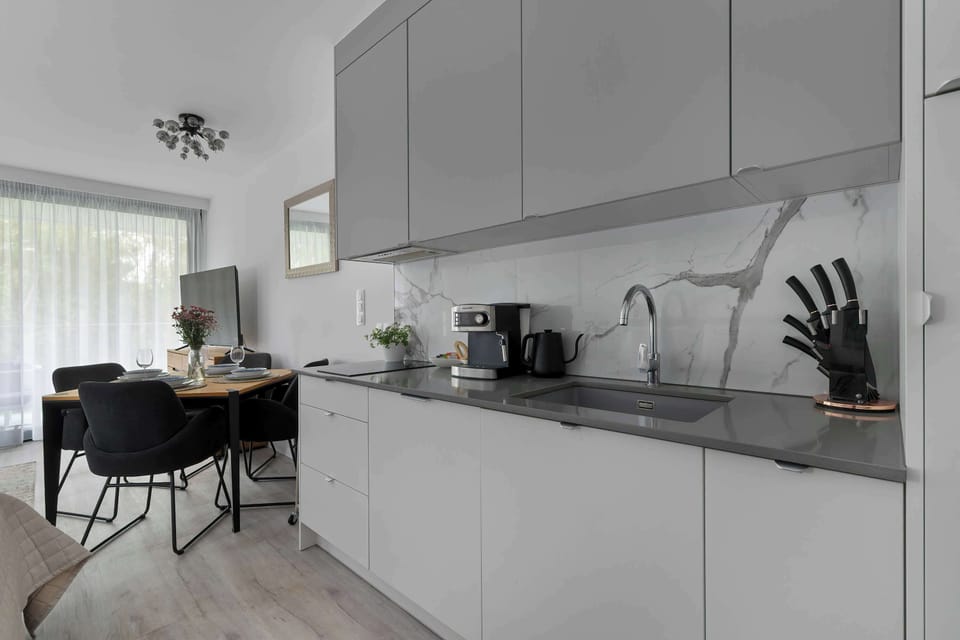 Modern kitchenette with sleek cabinets and built-in appliances.