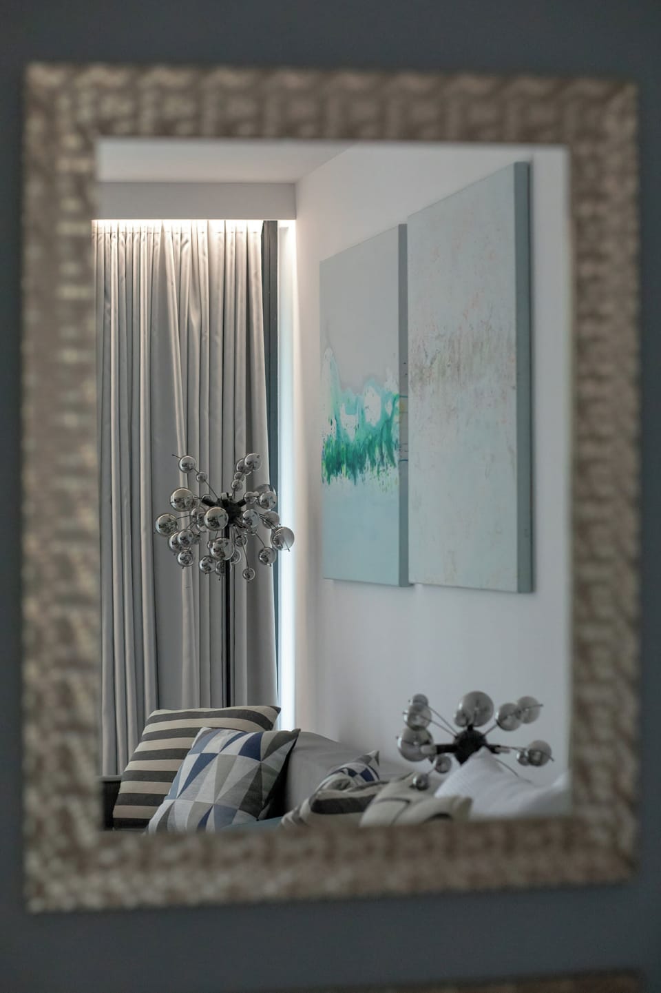 Elegant mirror reflecting the bright interior of the apartment.