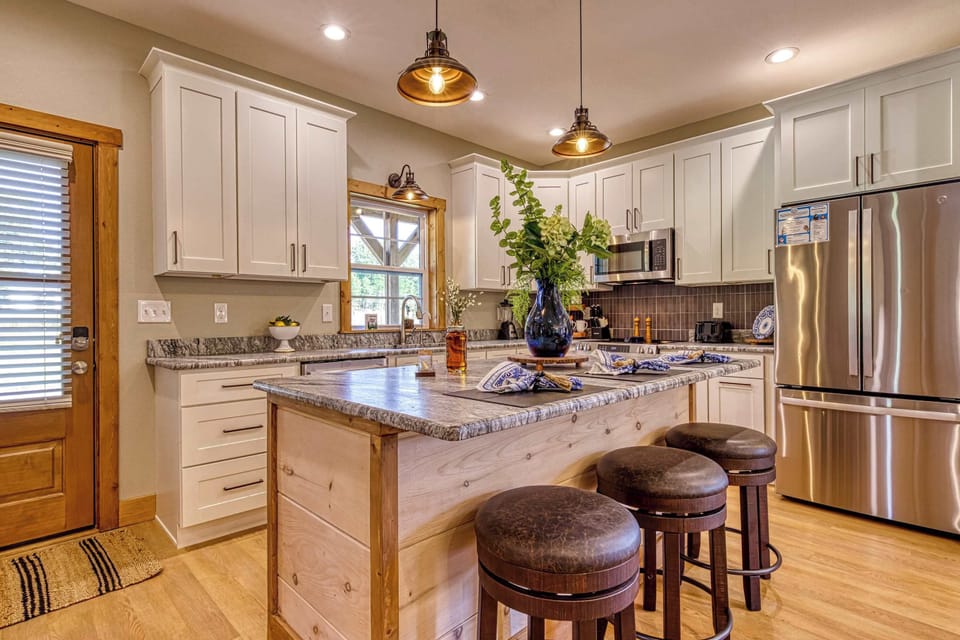 Start your mornings at the bar with coffee and mountain sunshine in this stylish gourmet kitchen.