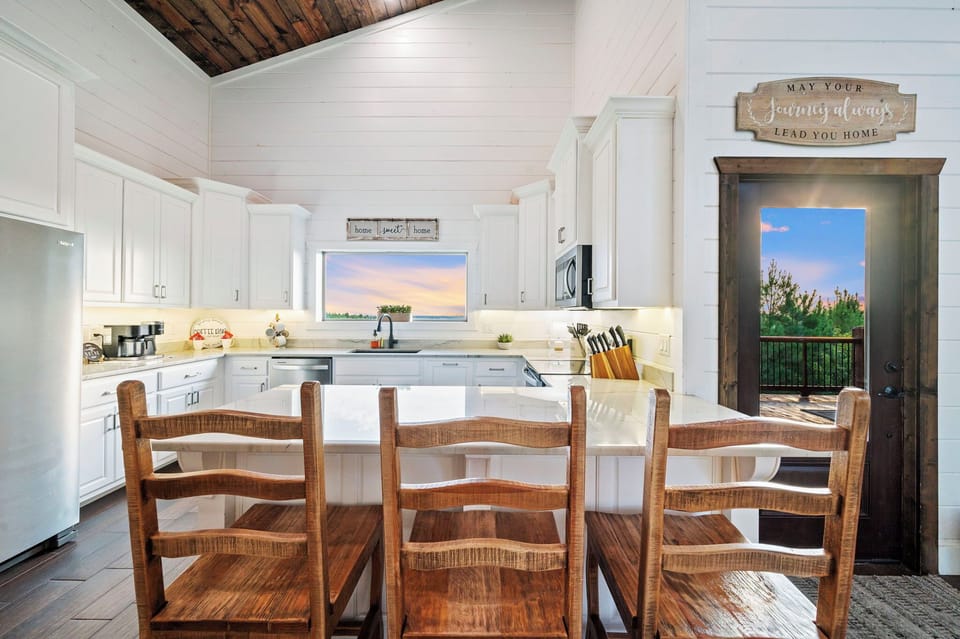 The white kitchen is open to the great room and has small appliances: crock pot, rice cooker, coffee maker, etc.