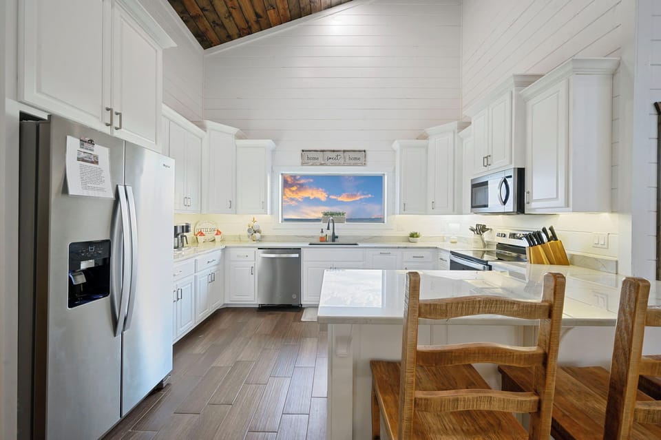 Prep meals in our clean kitchen with white countertops and stainless steel appliances