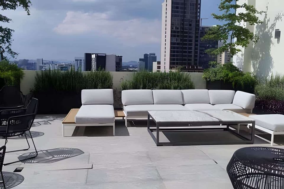 Shared rooftop terrace w/ loungers & greenery, a peaceful spot to unwind outdoors