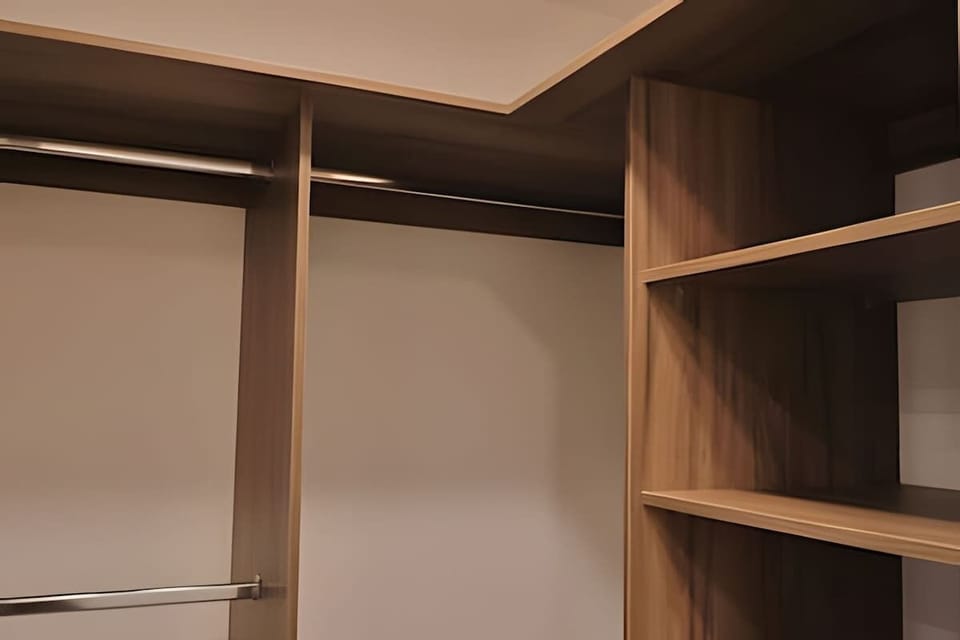 Spacious walk-in closet w/ hanging rails & shelves to keep everything neatly stored