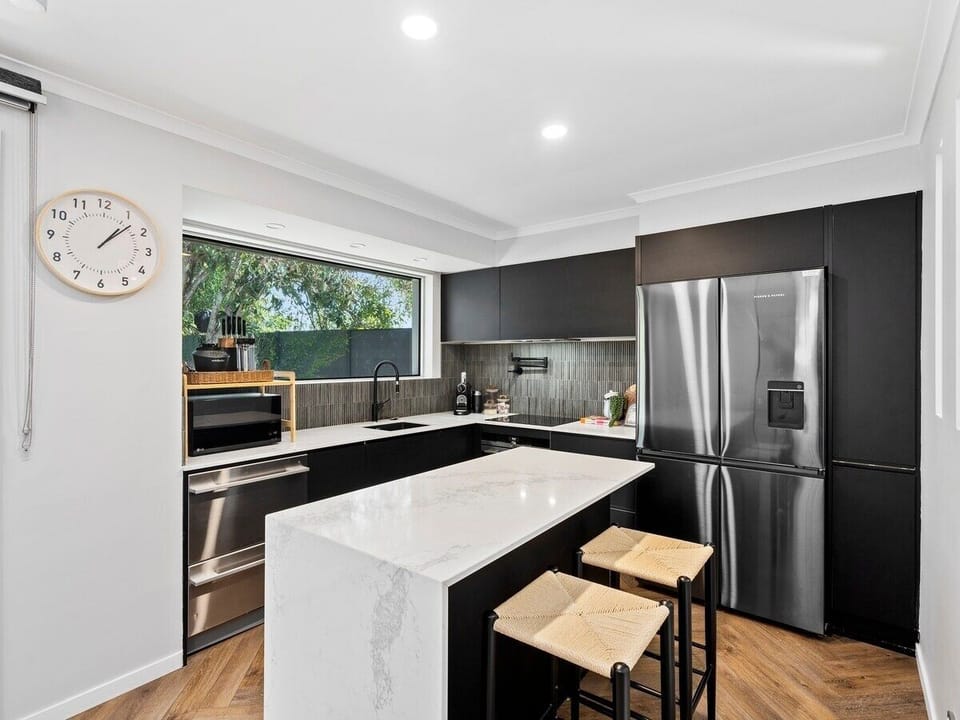 Fully equipped kitchen with oven, stovetop, microwave, dishwasher, and large fri