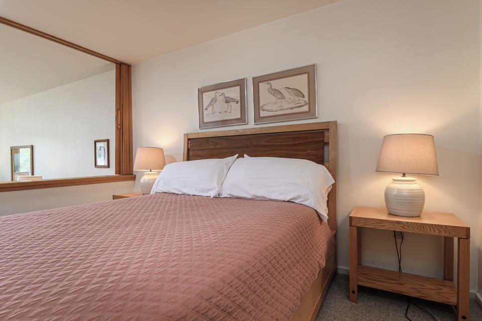 Cozy bedroom area with open view of the studio layout