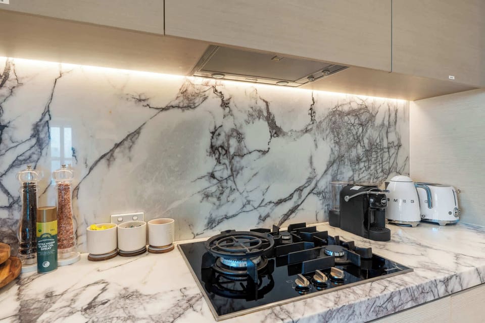 Elegant textures and warm lighting pair beautifully with the marble finishes, creating a sophisticated yet welcoming space to start and end your day.
