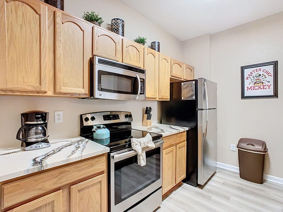 Bright and spacious kitchen featuring appliances, perfect for home cooking.