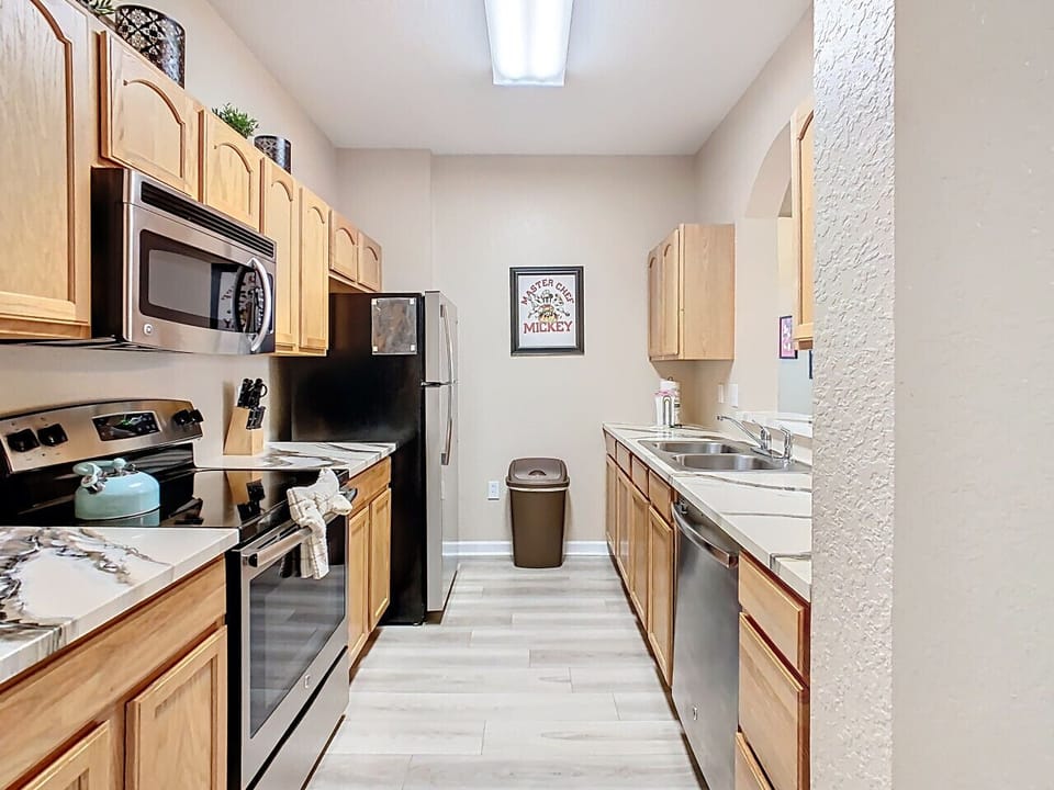 Open kitchen with all the essentials – stove, microwave, fridge, and cookware – ready for your stay.