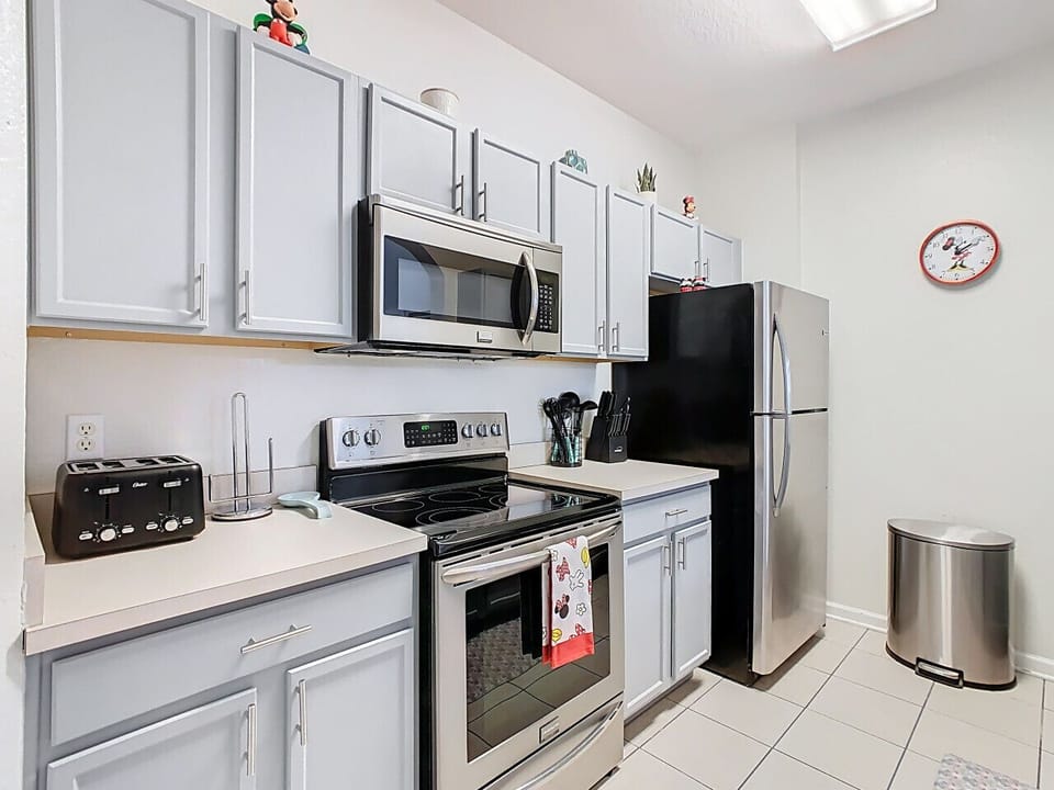 Cook with ease in the fully equipped modern kitchen featuring stainless steel appliances, plenty of space, and everything you need for family favorites or quick snacks.