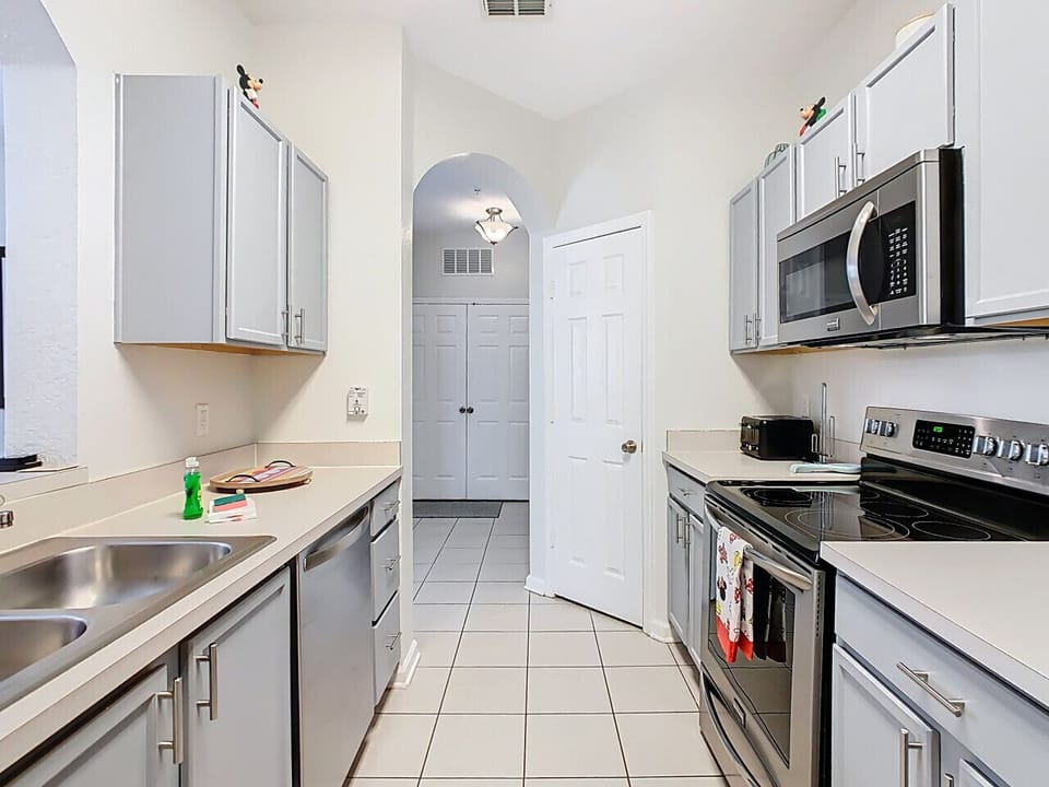 Cook with ease in the fully equipped modern kitchen featuring stainless steel appliances, plenty of space, and everything you need for family favorites or quick snacks.