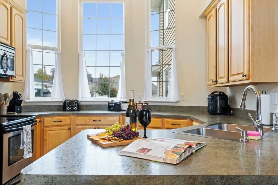 Kitchen island and large windows bring natural light to meal prep and gatherings.