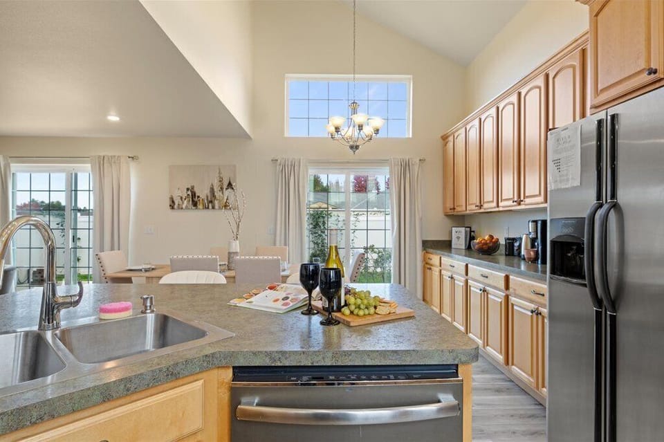 Fully stocked kitchen with breakfast bar, open layout, and modern appliances