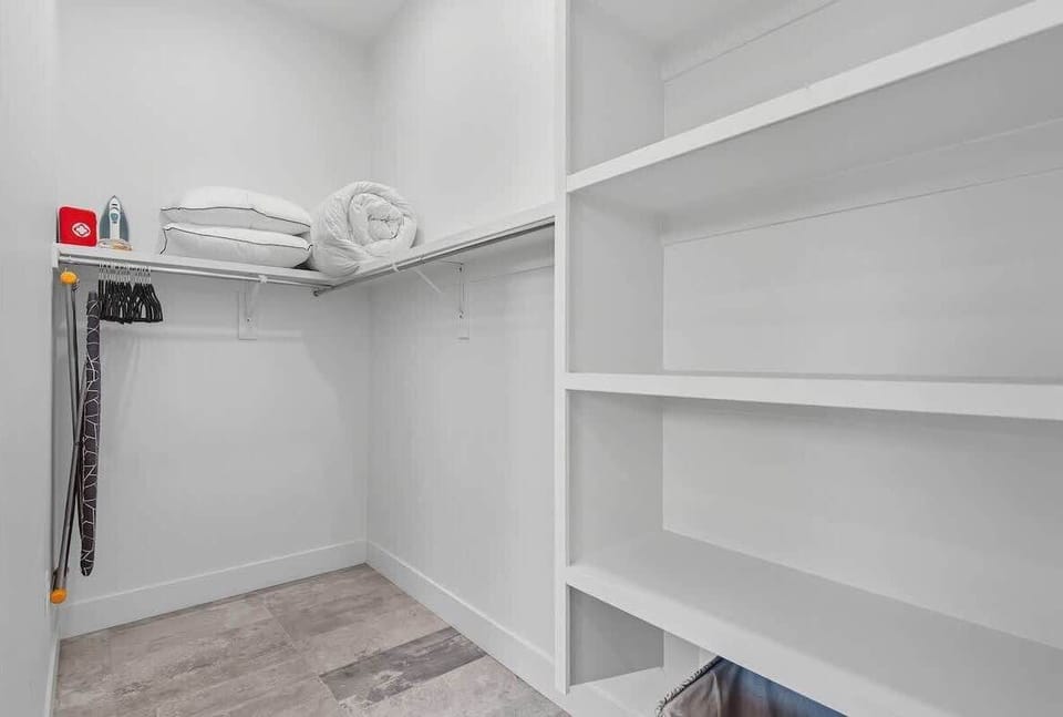 Primary bathroom with double vanity, large walk-in shower, and large walk-in closet. (3rd Floor)