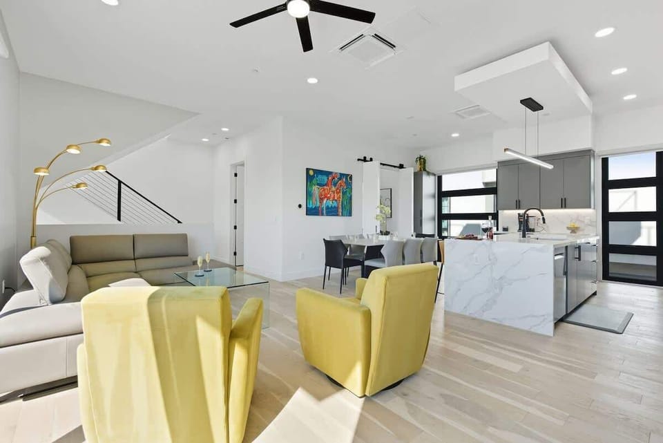 Bright open floor living space, designer furnishings, smart TV, and large sliding doors leading to the private outdoor oasis. (2nd Floor)