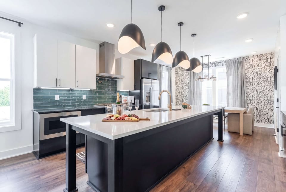 Island seating for twelve means group breakfasts happen here, pendant lights overhead, gas range ready, and room for everyone to gather while someone cooks