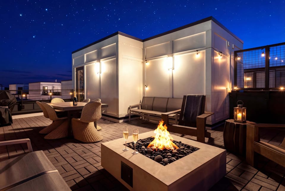 String lights and a fire pit transform the rooftop into an outdoor living room once the sun sets over the city