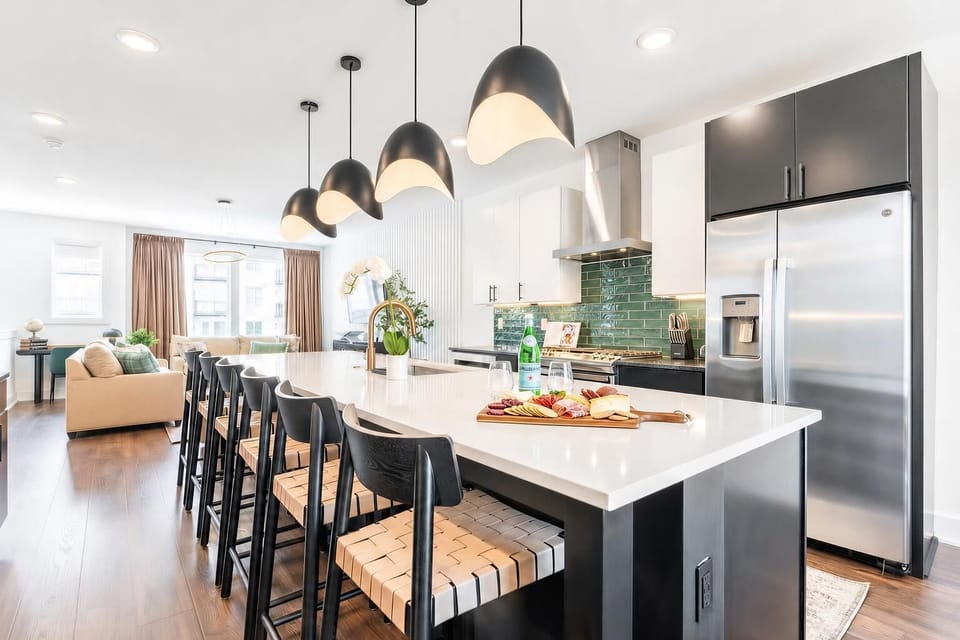 The island kitchen keeps the cook in the middle of things with bar seating on three sides and pendant lights that set the mood for group meals. Book your stay with Misfit Homes to experience it firsthand