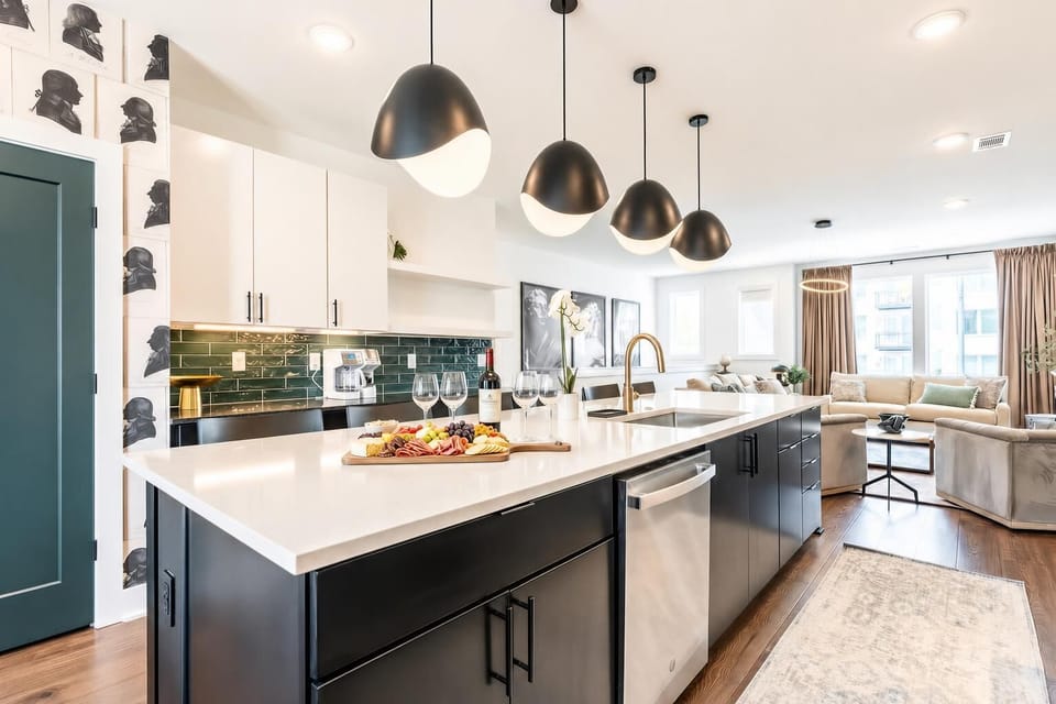 The island sink and dishwasher keep things moving through the day; the green tile backsplash is proof that function and style live together here