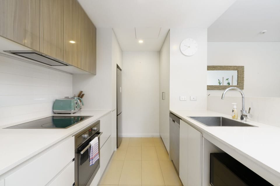 A sleek, modern kitchen with stylish mint-green appliances and clean finishes.