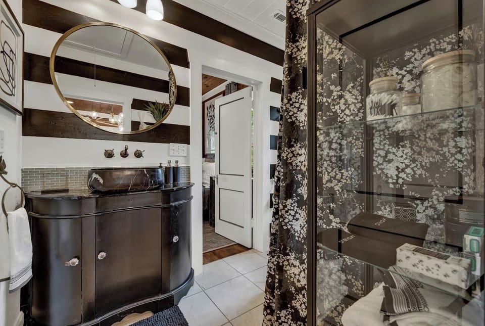 Enjoy a spa-inspired space with sleek finishes, fresh towels, and thoughtful amenities for a relaxing stay.