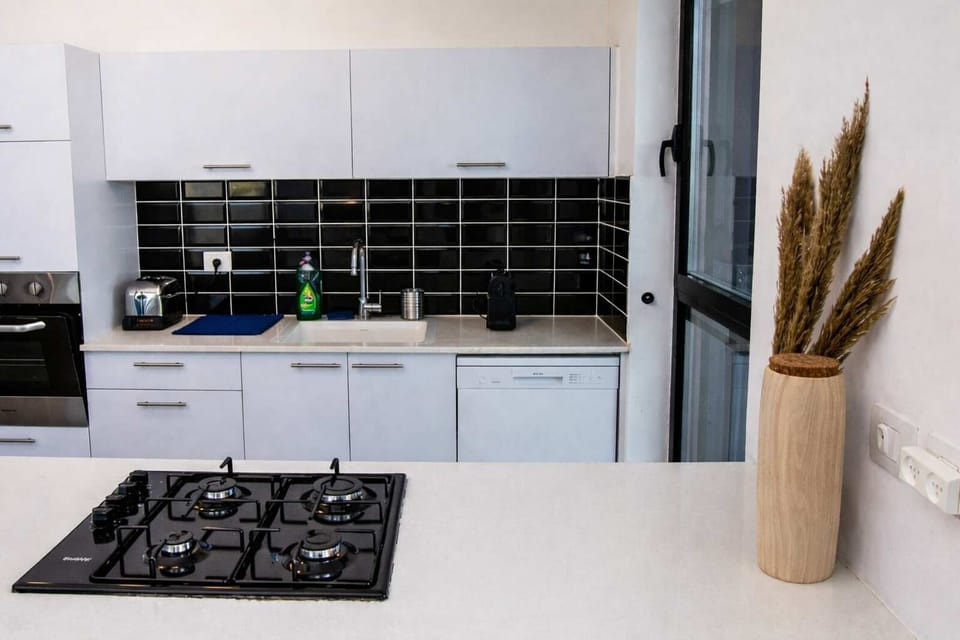 Contemporary kitchen design supports easy meals, with shops and dining options just outside your door.