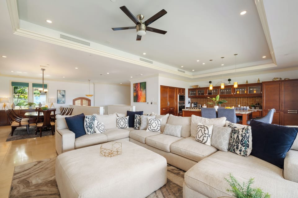 This spacious layout blends comfort and style with a plush sectional, vibrant kitchen, and refined dining area—ideal for entertaining or unwinding in luxury