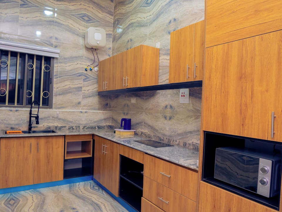 Deluxe Room | Private kitchen | Fridge, microwave, dining tables