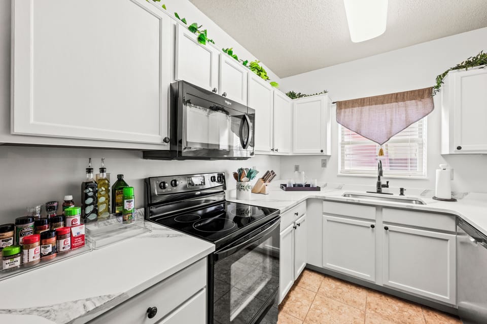 This beautifully updated kitchen features new countertops, generous workspace, an extra-deep sink and all the essentials for prepping a lovely meal